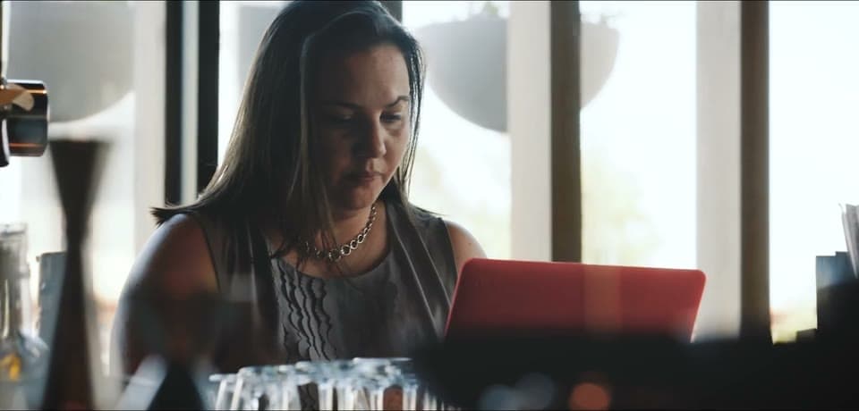Alix Rumsey working on a laptop in a Los Angeles restaurant